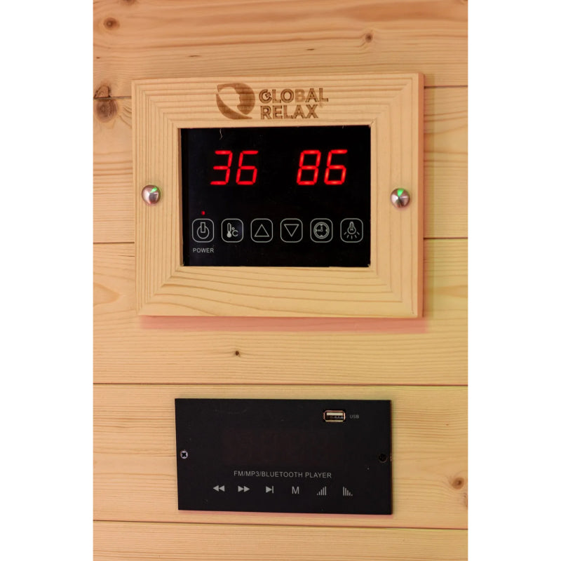 Digital control panel with temperature display on a wooden wall, featuring the brand 'Global Relax'.