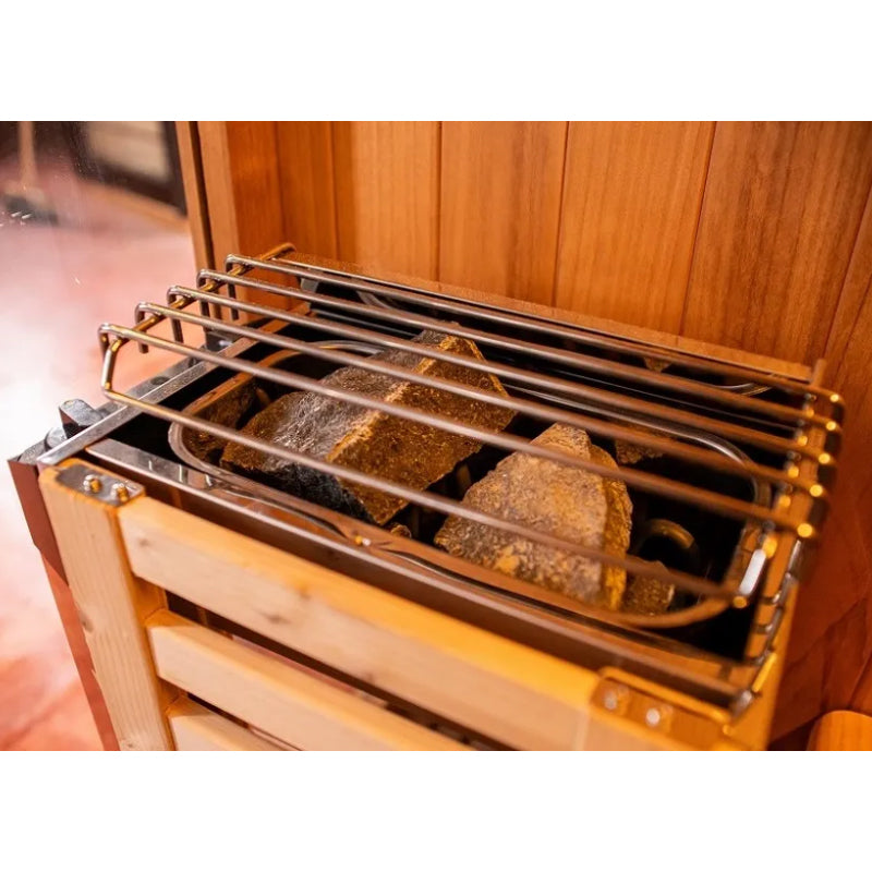 Wooden sauna with metal racks and stones inside
