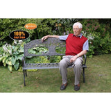 Gardeco Cast Iron Bench With Tree In A Garden Setting With A Man Sitting On It | SKU: BENCH-TREE | Barcode: 5031599039459