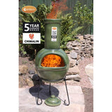 Gardeco Sempra Large Glazed Green Chimalin AFC Chiminea With Burning Logs Inside In A Sunny Garden Setting | SKU: AFC-C21.77 | Barcode: 5031599046426