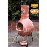 Side View On Gardeco Large Sol Mexican Chiminea In Rustic Orange With Burning Logs Inside | SKU: C21SL.37 | Barcode: 5031599045481