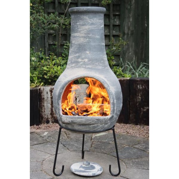 Gardeco Extra Large Mexican Dos Bocas (2 mouths) Chiminea In Grey With Burning Logs Inside In A Garden Setting | SKU: C8DB.56 | Barcode: 5031599051307
