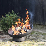 Esschert Design Black Steel Sloping Fire Bowl With Burning Logs In A Garden Setting | SKU: 422496 | UPC: 8714982142727
