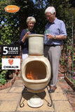 Gardeco Asteria Extra Large Cappuccino Chimalin AFC Chiminea With Burning Fuel Inside In A Garden Setting With 2 People | SKU: AFC-C51.73 | Barcode: 5031599044552