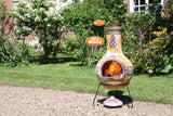Fired Up Gardeco Extra Large Azteca Mexican Chiminea In Yellow In A Garden Setting | SKU: C8AZ.01 | Barcode: 5031599030913