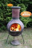 Fired Up Gardeco Extra Large Plumas Mexican Chiminea In Green In A Garden Setting | SKU: C8PL.03 | Barcode: 5031599030883