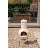RedFire Star Flower Clay Chiminea / Outdoor Fireplace In Straw Colour With Logs Inside In A Garden Setting | SKU: 411837 | Barcode: 8718801854754